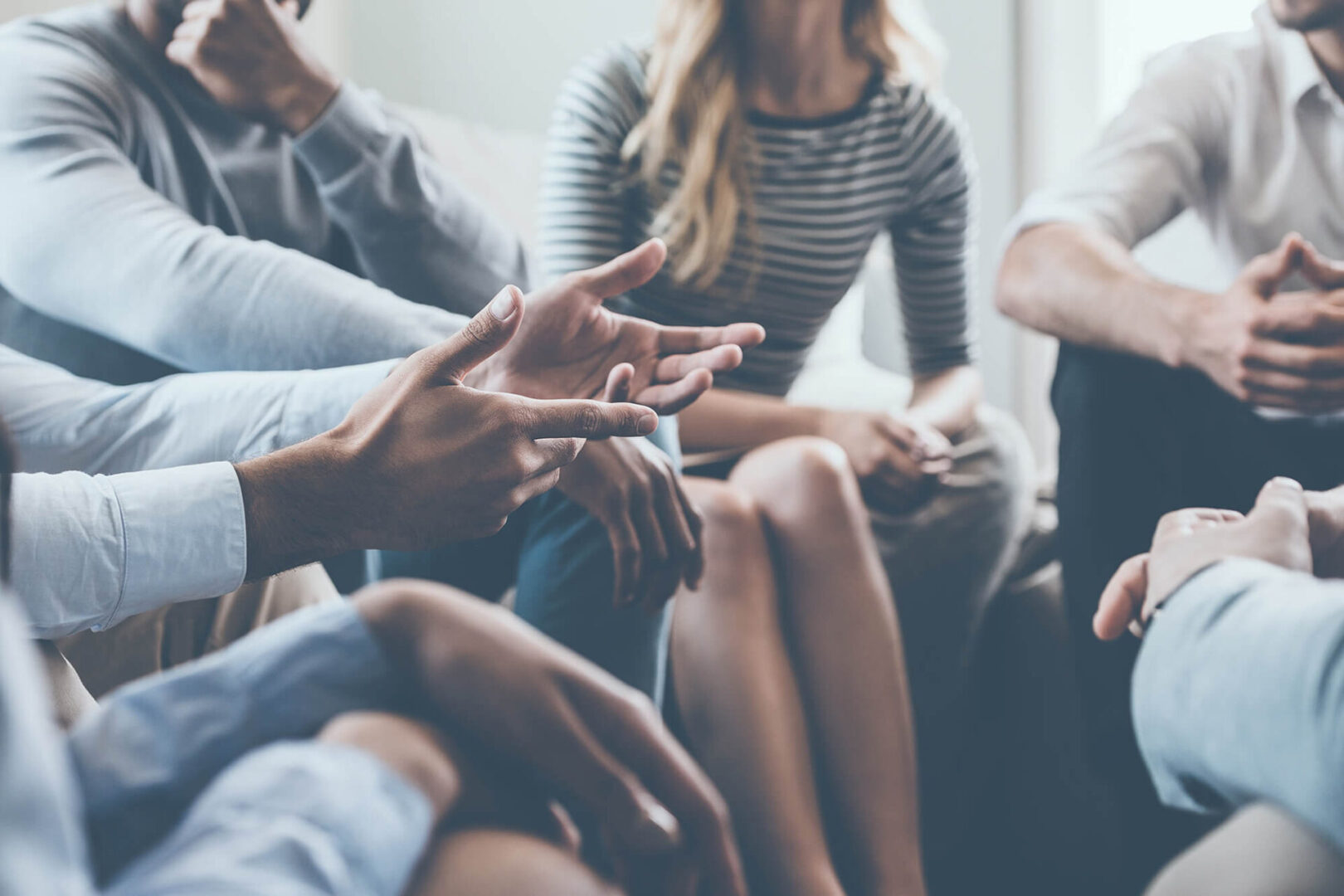 A group of people sitting around each other.